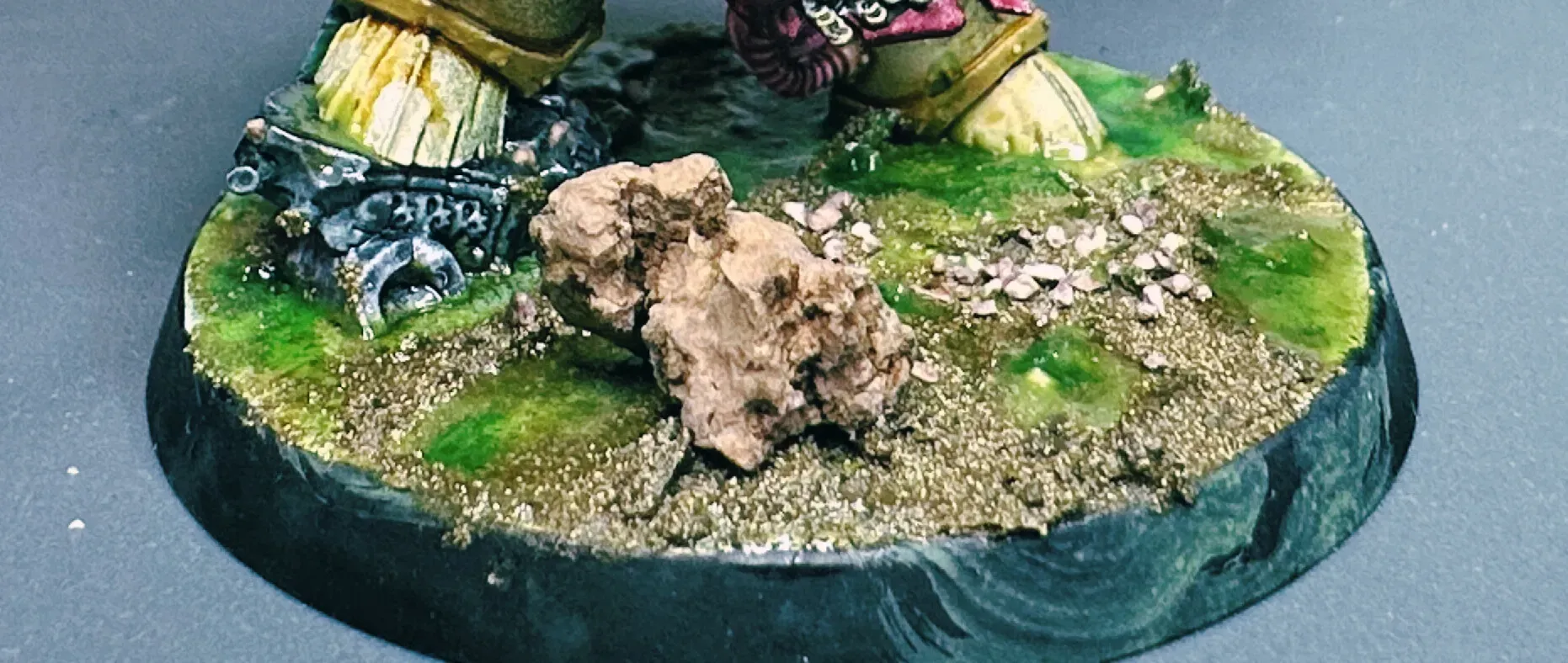 Character base close-up with cork rocks, dark earth, and layered green toxic puddles