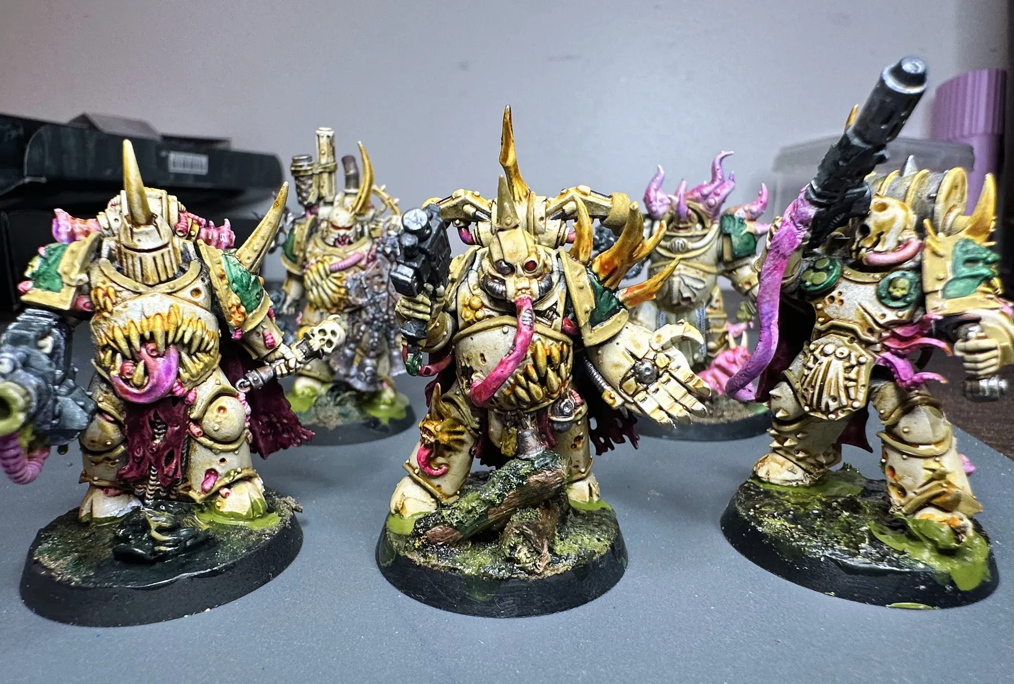 Death Guard army front view showing bone armor paint scheme across Plague Marines, Terminators, and characters