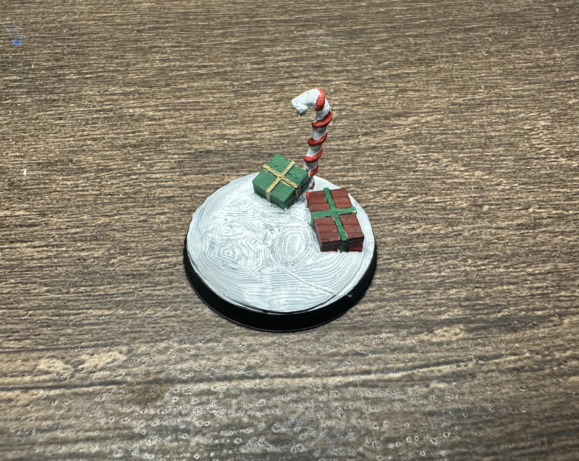 Standing candy cane with presents miniature base painted in red and white stripes