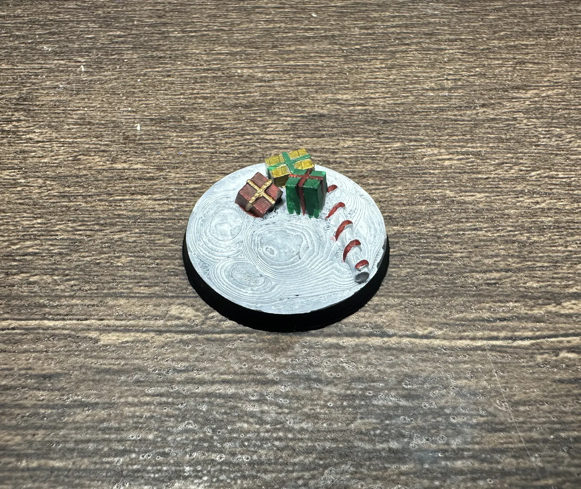 Painted presents and candy cane miniature base in red, green, and gold