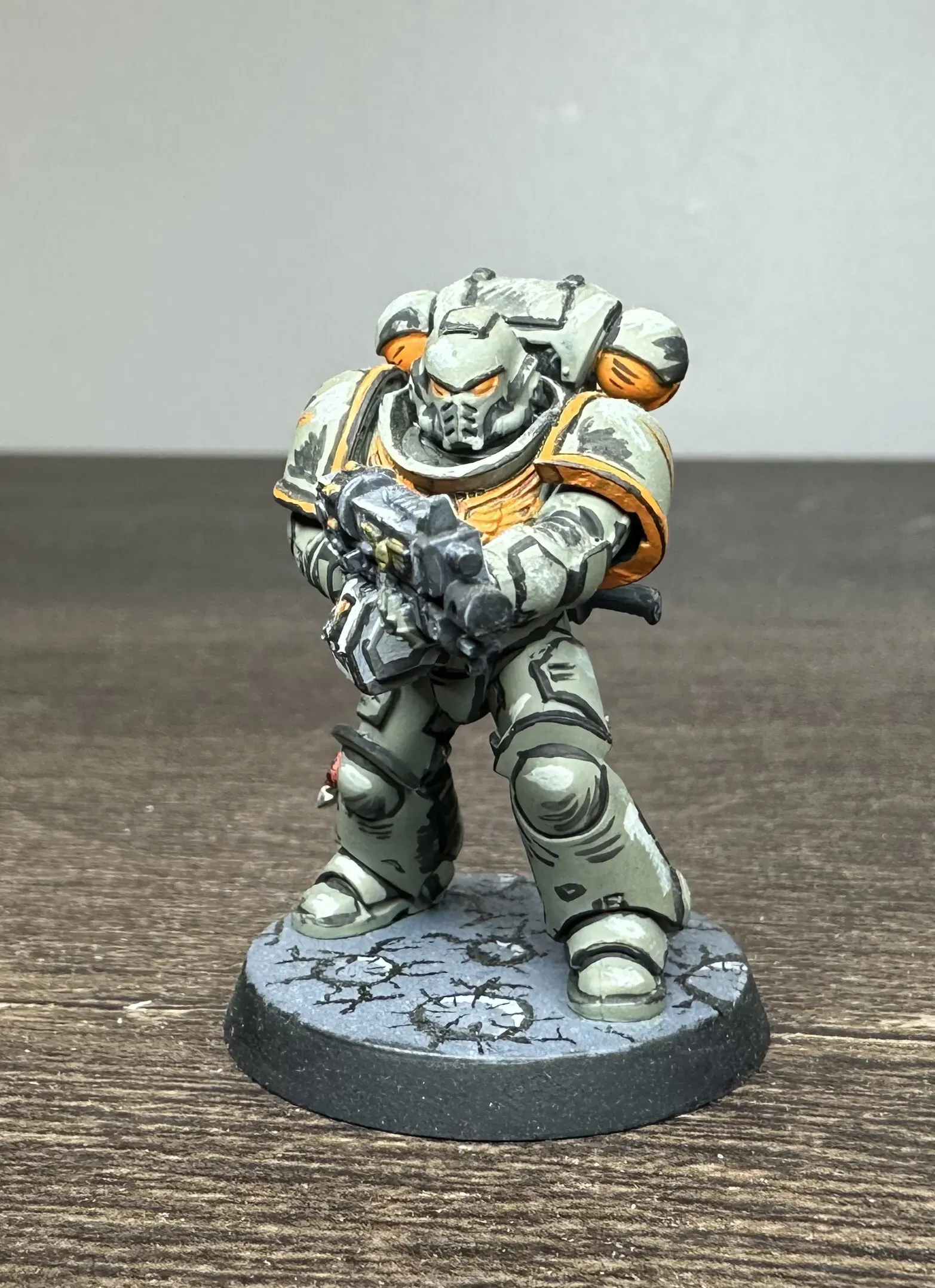Custom chapter space marine in green-grey armor with orange trim, painted in comic book style