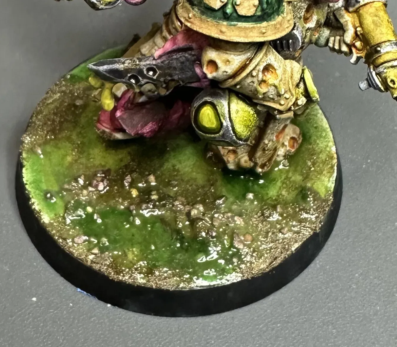 Top-down close-up of a Death Guard base showing layered toxic green sludge texture
