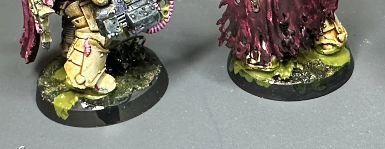 Two Plague Marine bases from a low angle showing a more solid painted-looking toxic effect