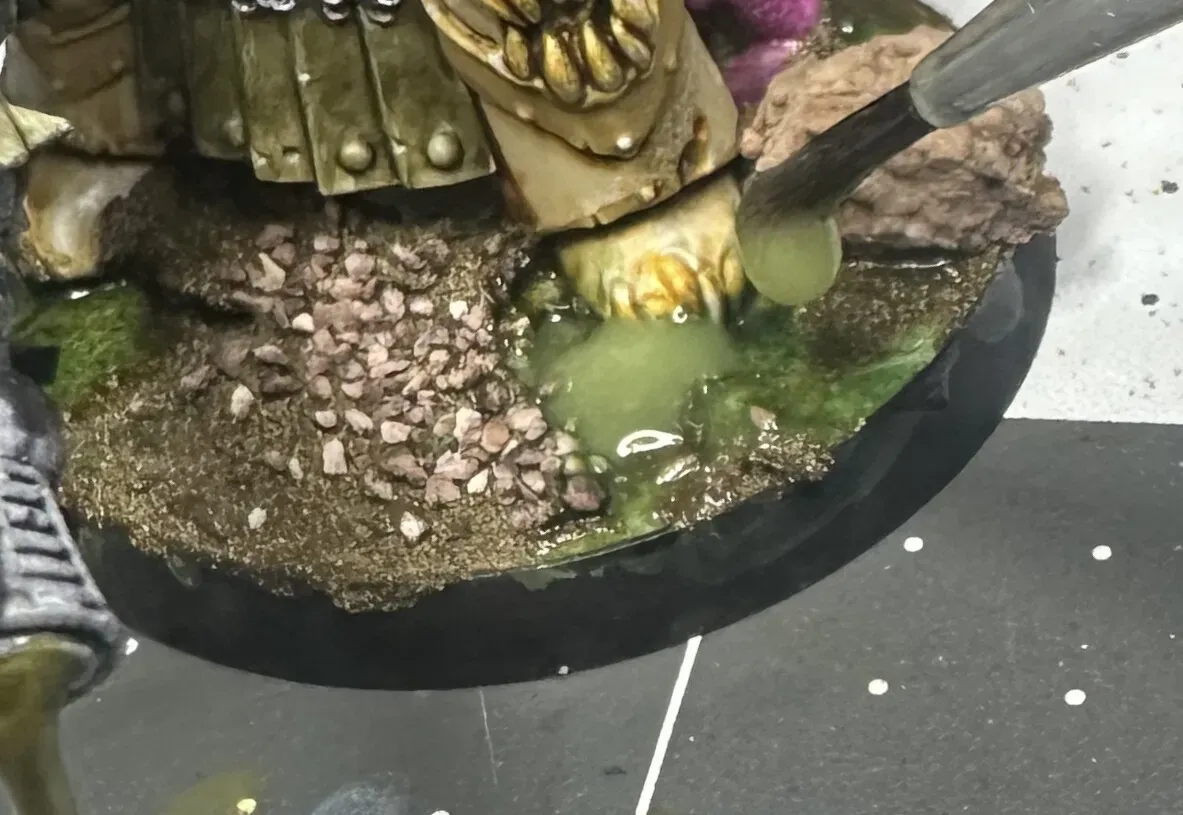 Applying the toxic sludge mixture to a Death Guard base with a brush