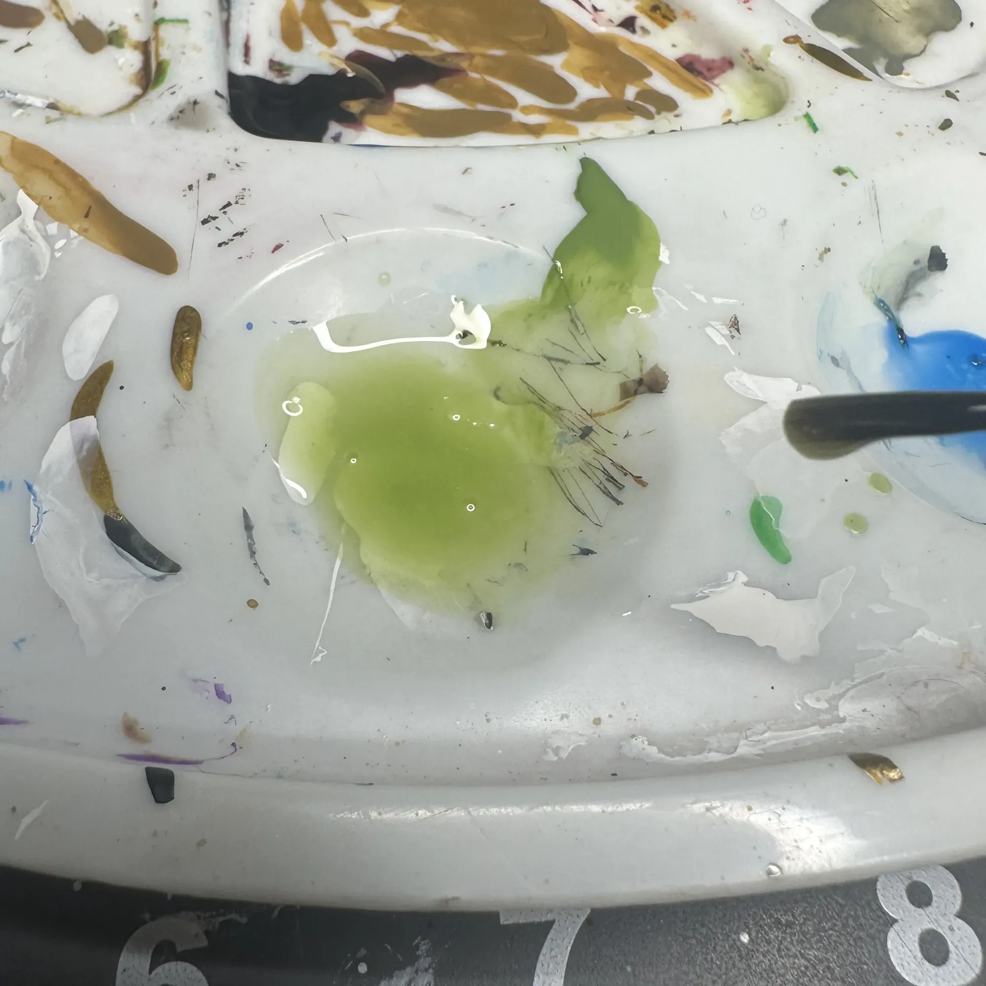 Palette showing translucent water texture and paint mixture used for toxic base layering