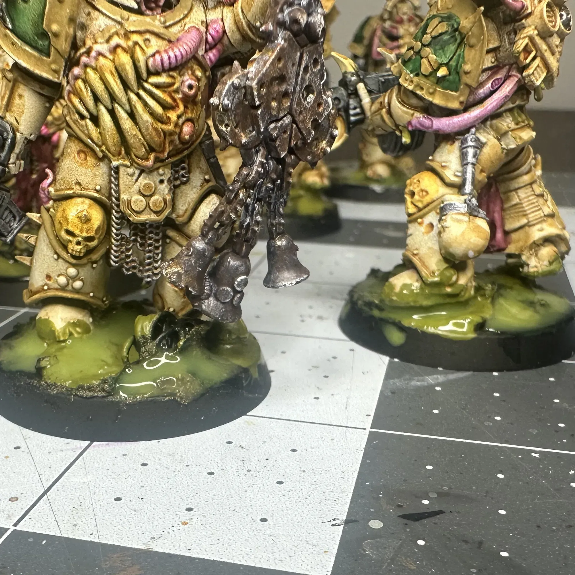 Close-up of Plague Marine bases after layering fix showing translucent green sludge depth